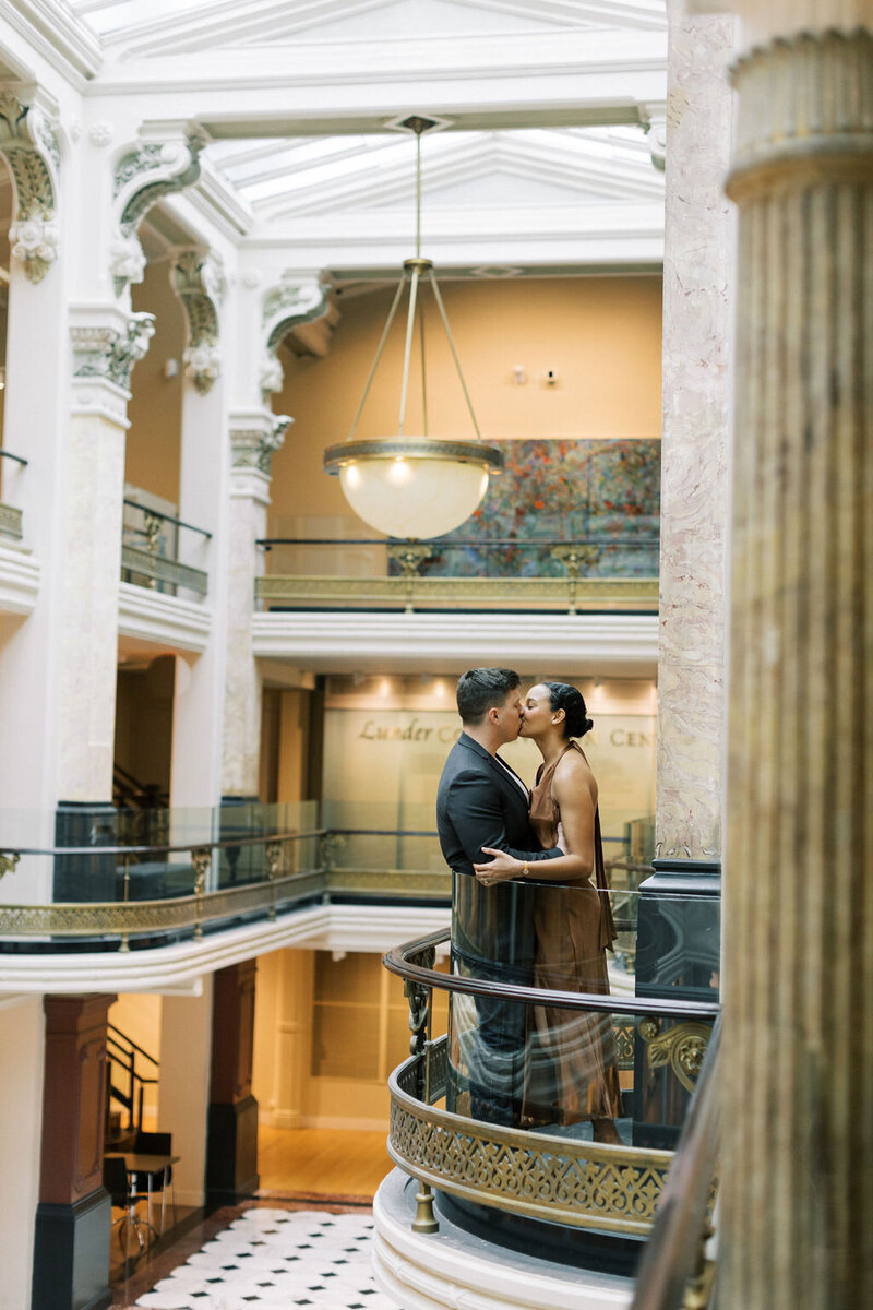 Bride and groom kiss for photos inside the National Portrait Gallery