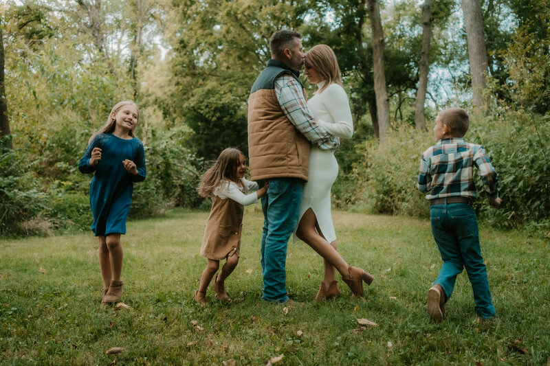 Couple dipping in front of family and friends cheering for wedding