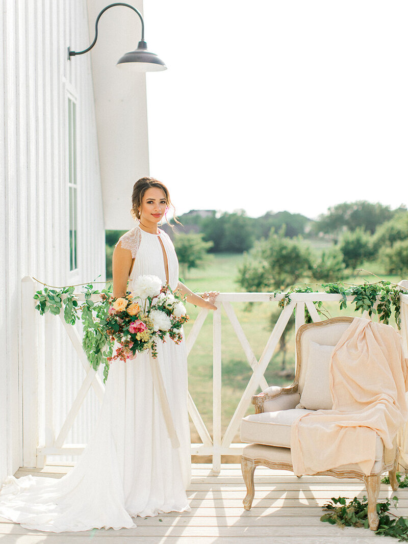 bride posed on patio of The Nest wedding venue