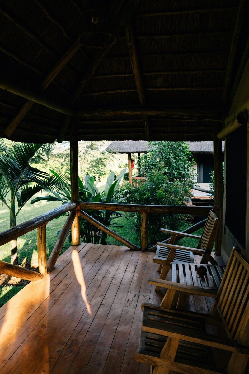Wooden porch with chairs and a gazebo in the background
