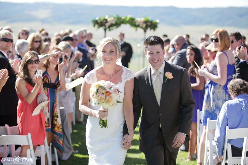 Couple walk down the aisle at their Bella Vista Estate Summer Wedding in Steamboat Springs Colorado