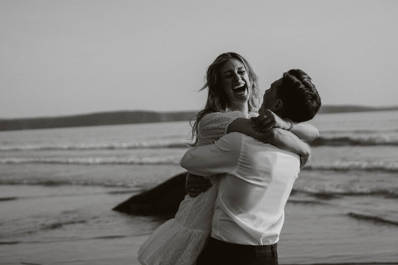 Engaged couples kissing on the beach in Pembrokeshire