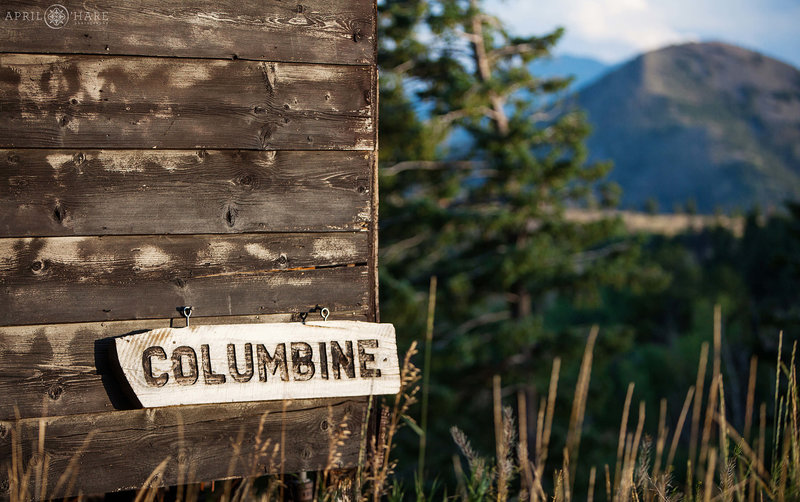 Rustic building called Columbine with mountains in the distance at a summer camp in the mountains of Boulder Colorado