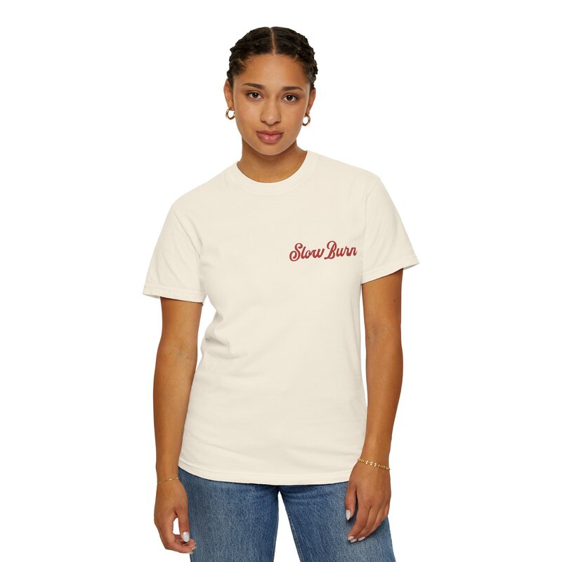 A woman wearing cream and red graphic t-shirt that says slow burn.