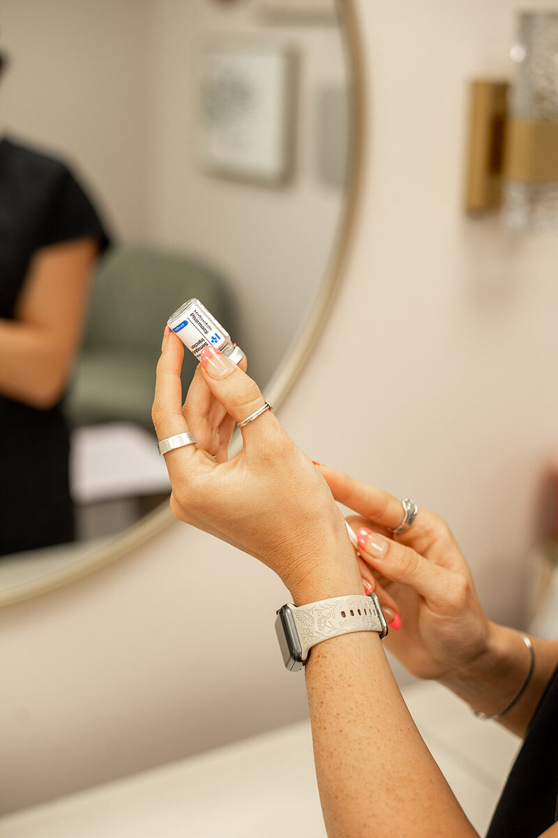 female hands drawing weight loss medication into syringe