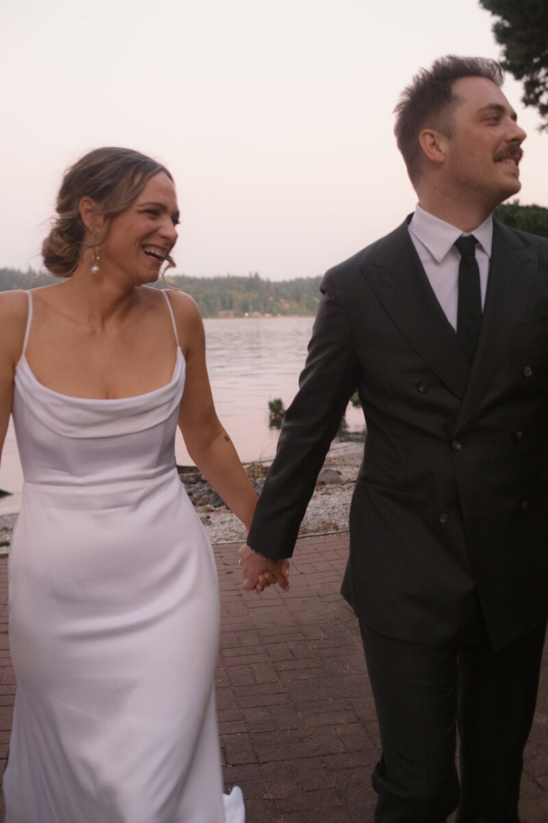 bride and groom walking on beach in Kingston wa