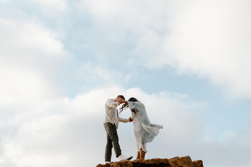 couple standing on rock