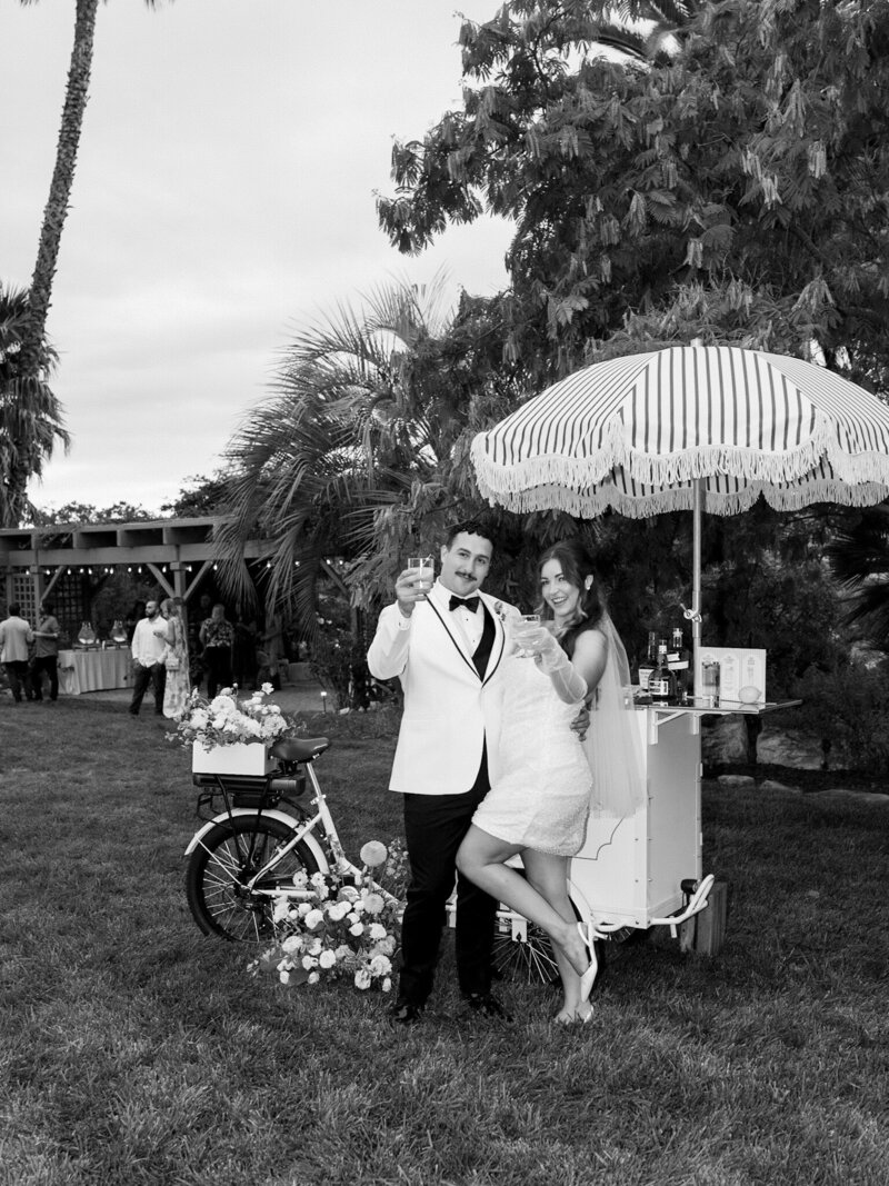 bride and groom during candid moment on their wedding day running through the vines