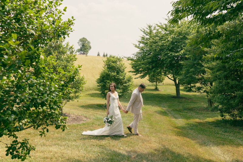 bride and groom walking in garden at virginia wedding