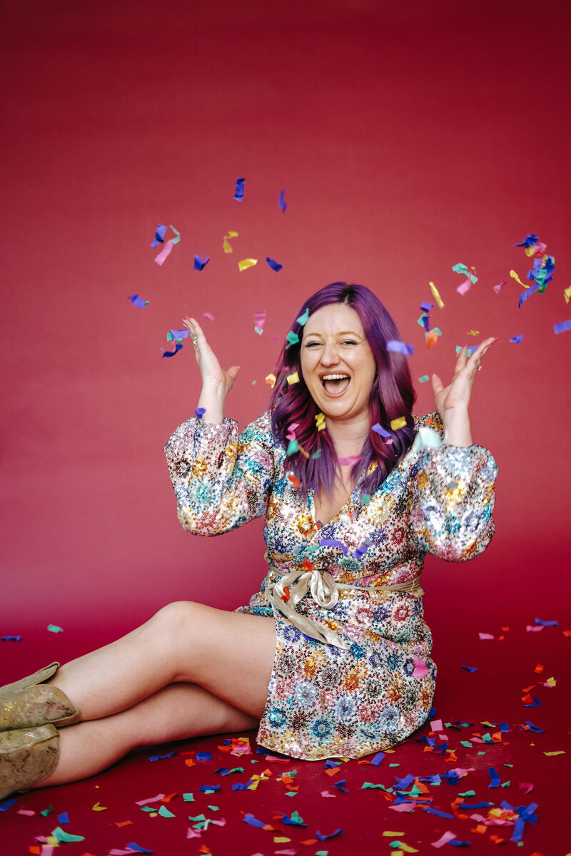 Photography Business Coach | Karinda K | Karinda celebrating while throwing confetti