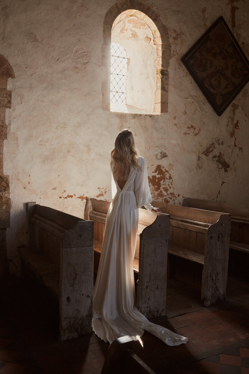 Deep v back silk wedding dress on bride in church