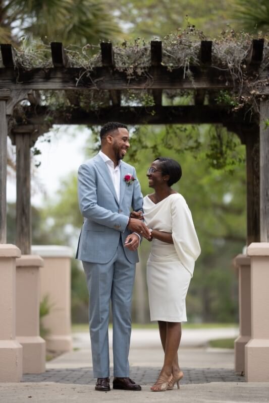 Joyful couple under arbor