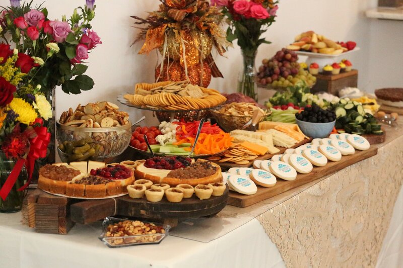 Hand holding two plates of catered food at event