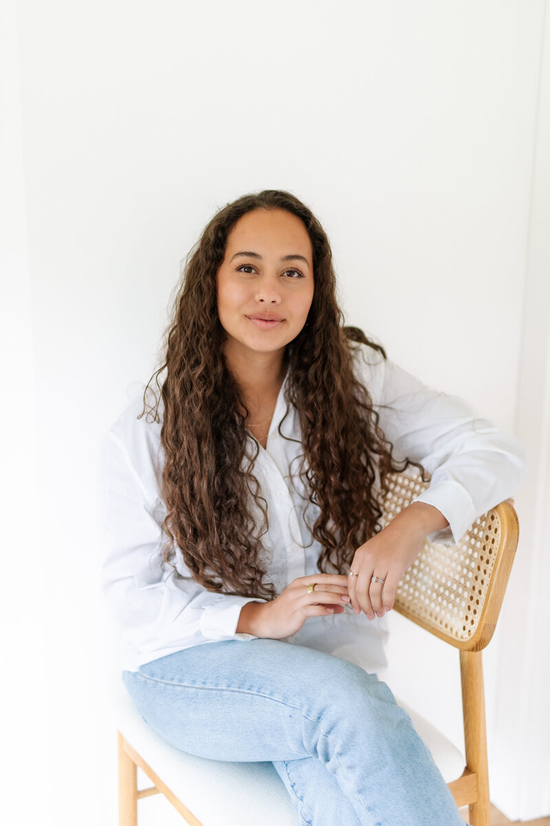 Wedding content creator, Makana Arvizu, sitting in a chair in Encinitas, California.