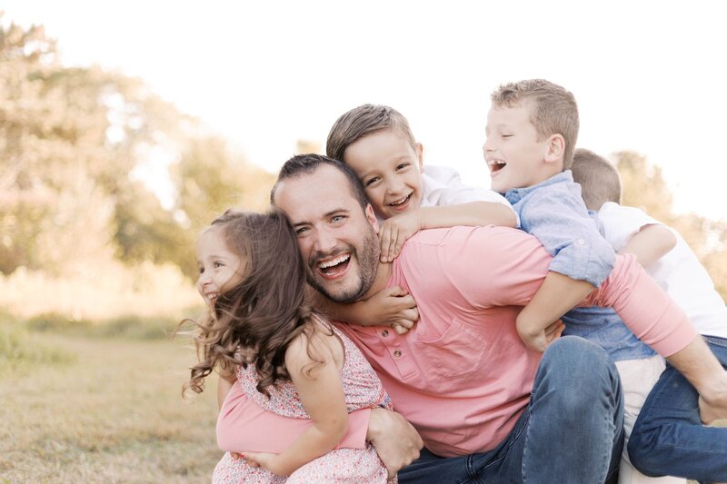 family outside in peach orchard for peoria illinois family photos 