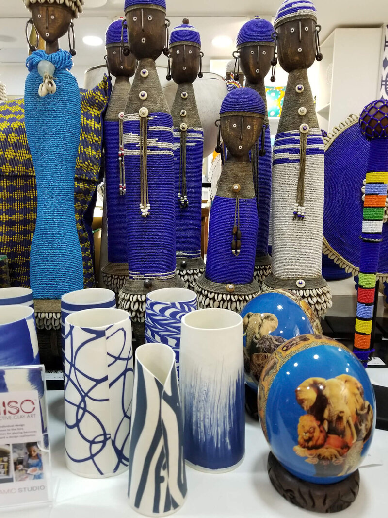 a group of blue and white vases and statues