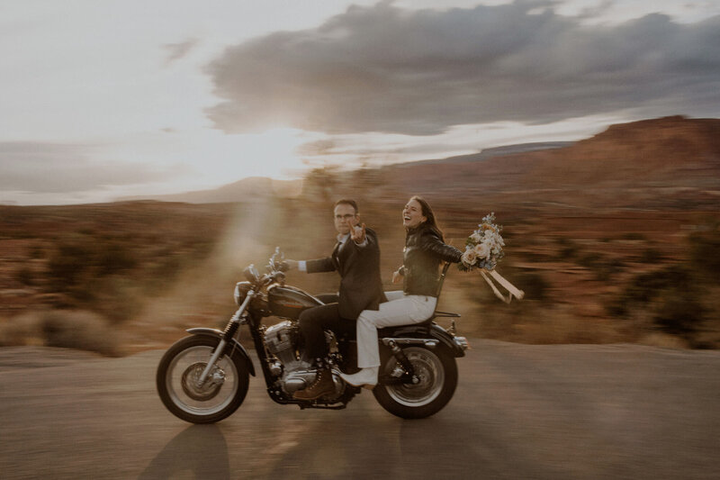 Couple rides their motorcycle in Capitol Reef National Park for their elopement