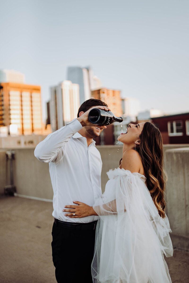 fiance-pouring-champagne-into-bride-to-bes-mouth