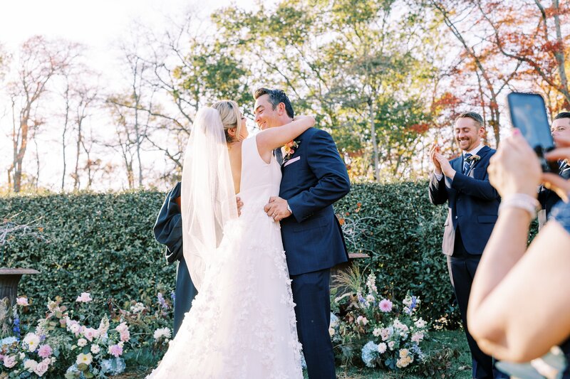 Bride and groom kiss at the altar