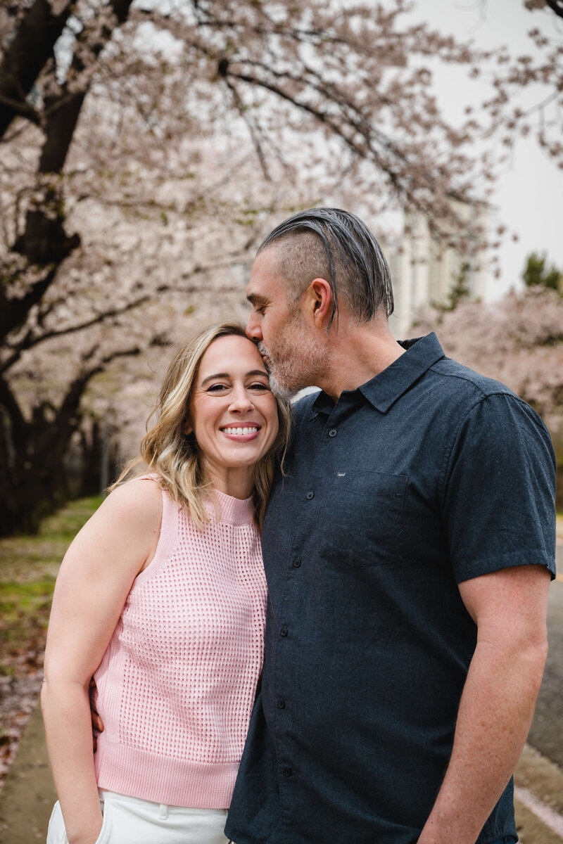 Family of four standing under cherry blossoms in Seoul — sharing expat reflections and parenting stories on Leaving Main Street
