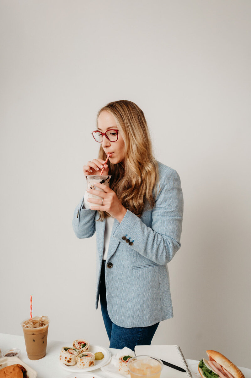 woman sipping on a chocolate milkshake