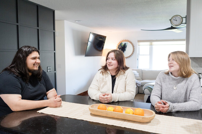AMK Cleaning Services team sitting at a kitchen counter