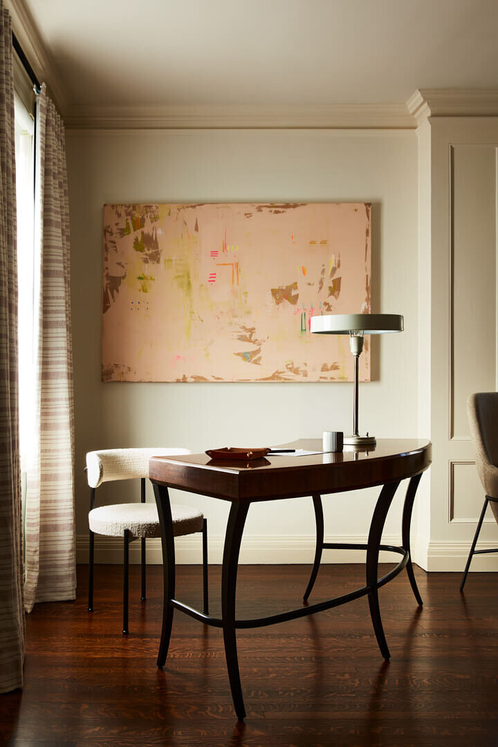 A vintage desk meets a modern chair and contemporary art in this refined historic home. Designed by Sarah Scales, Boston interior designer.