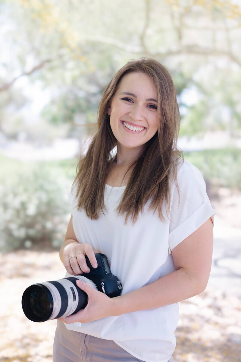 Las Vegas wedding and portrait photographer, Jessica Bowles, poses for a portrait in a grassy area