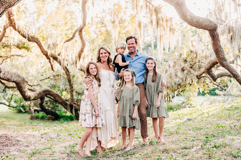 Three generations posing under the oak trees and enjoying holiday mini sessions.