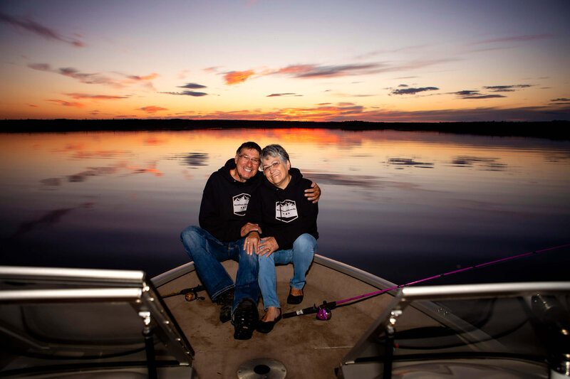 couple embraces at sunset on their boat