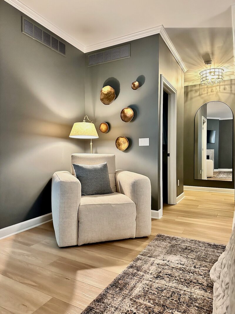 Large puffy chair tucked into a corner of a bedroom