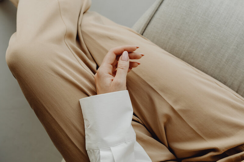 Professional woman with hands folded in lap—symbolizing poise, reflection, and intentional career decisions