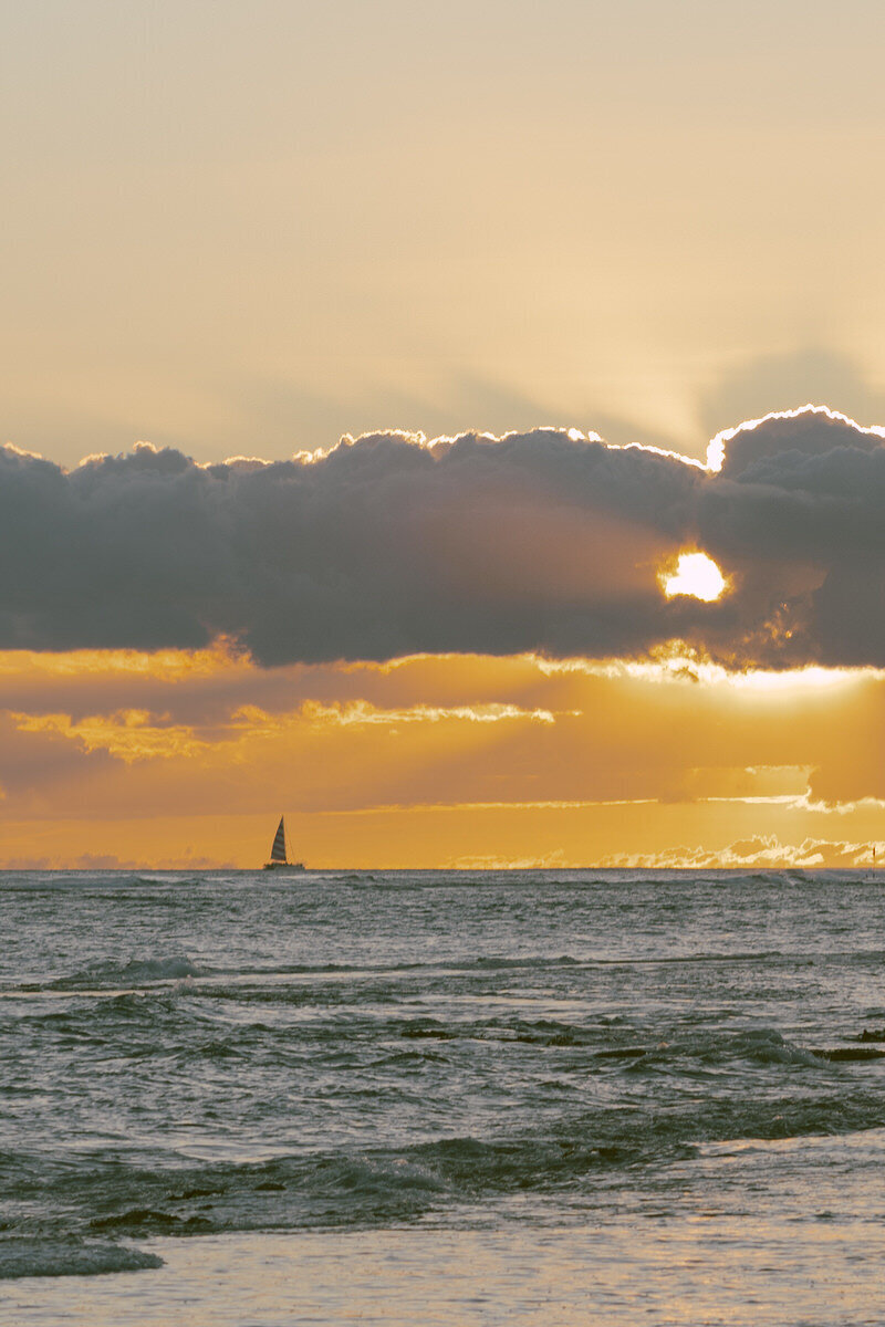 A sailboat at sunrise.