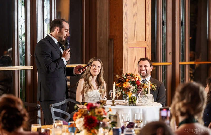 Wedding toast inside Mitchell Hall at Denver Botanic Gardens wedding reception