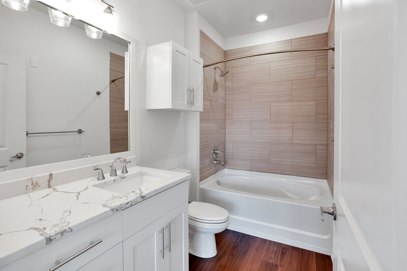 full bathroom remodel and design with LVT floors and tiled shower walls. 