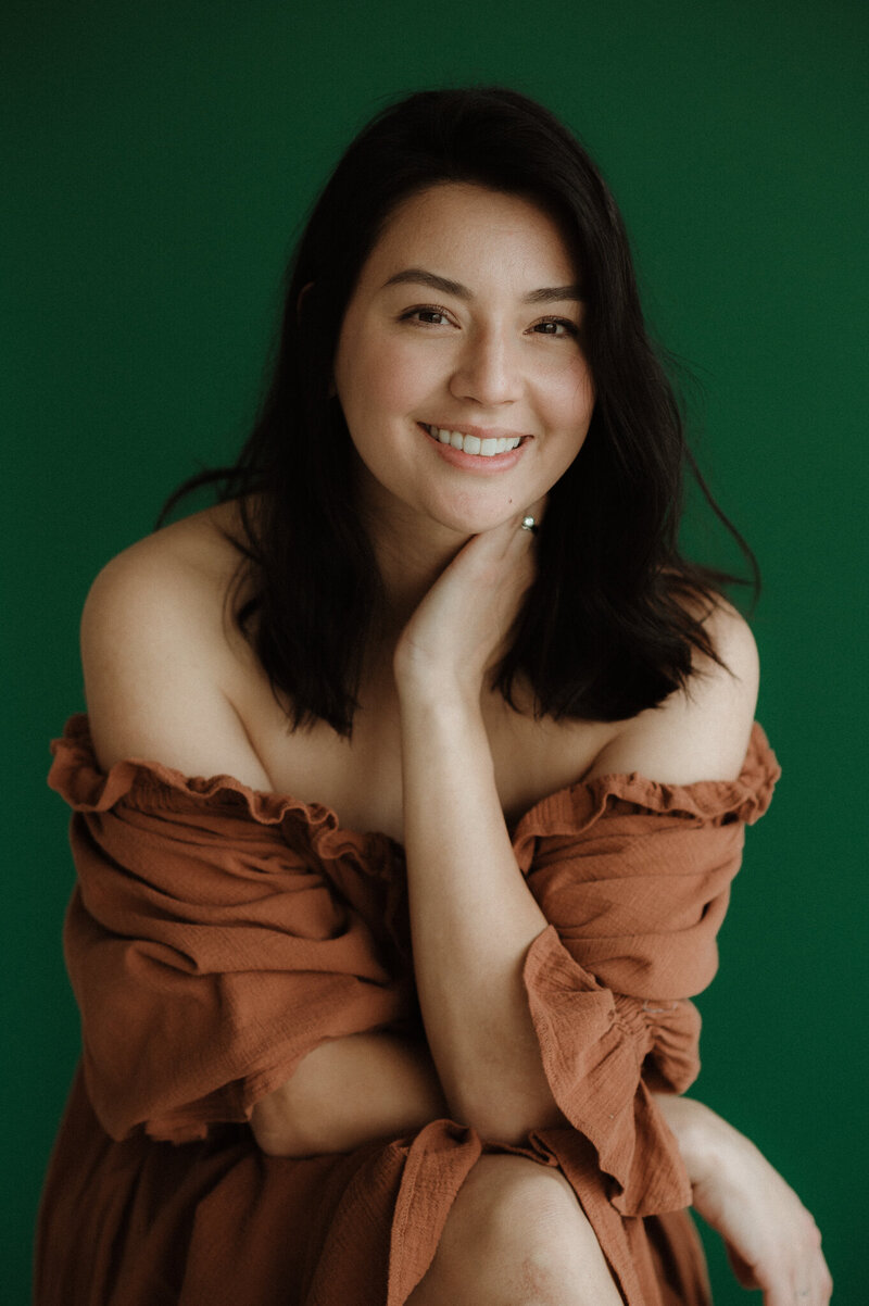 photographer wearing green dress in flowers