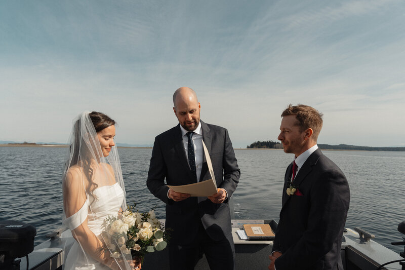 Bride and Groom exchanging vows on their Kingfisher boat on Vancouver Island