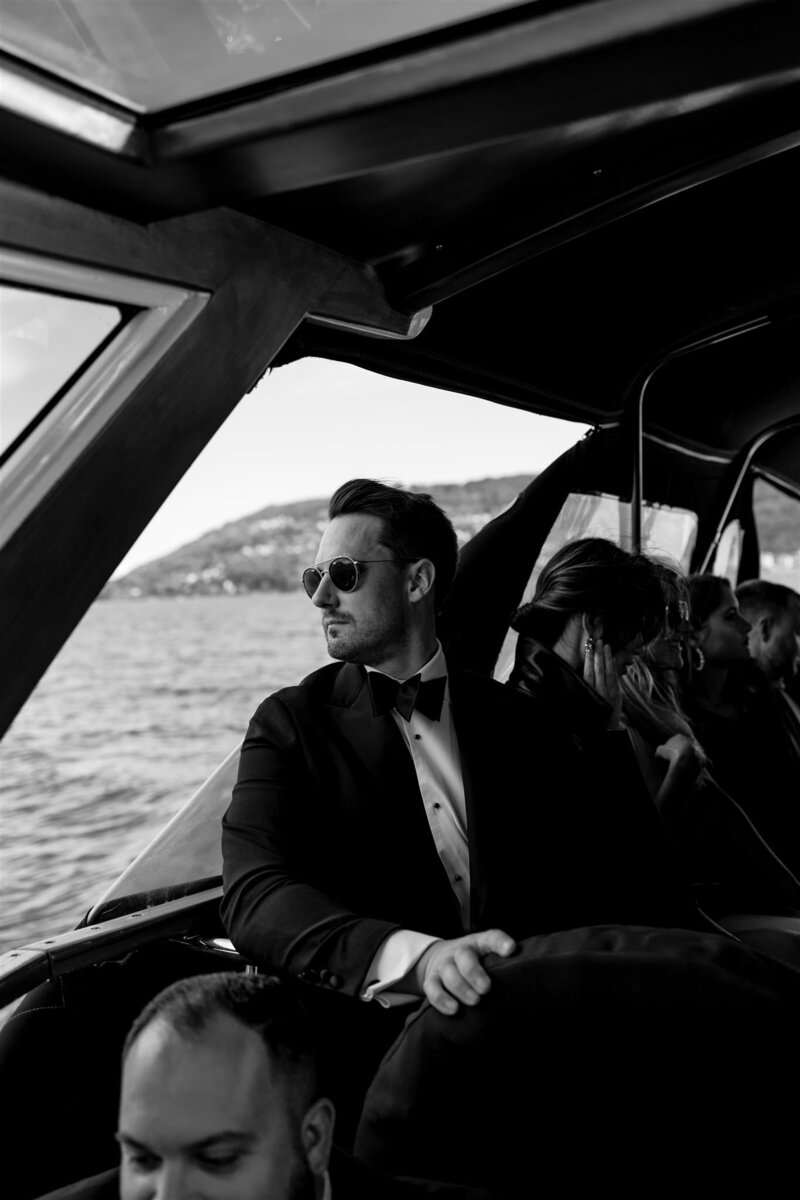Stylish groom on a boat in an Italian lakes wedding