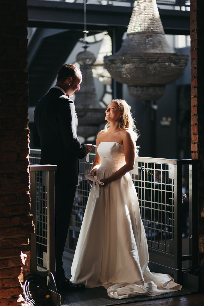 bride watches groom share wedding vows