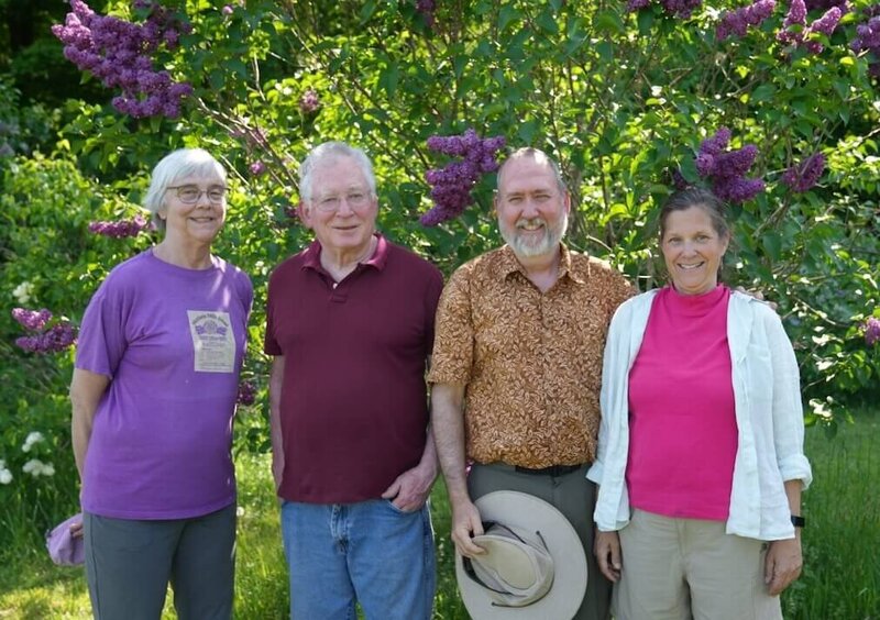 Original owners Cliff and Janice Westerling with new owners Wil and Rebecca Rivers standing in front of lilac bush