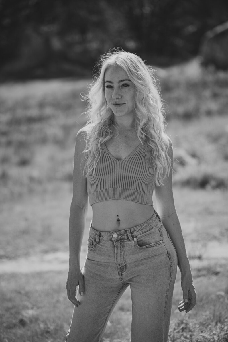 woman standing in a field looking at the camera
