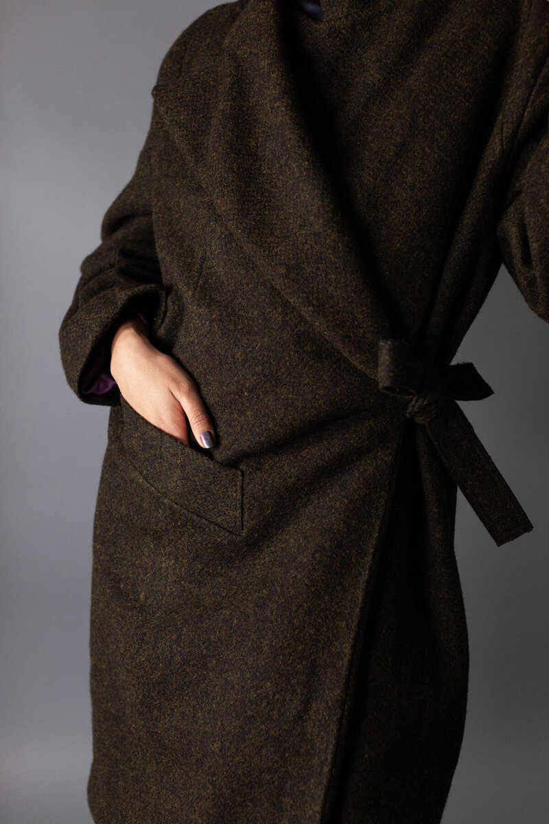 Close up of model with hand inside wool jacket pocket