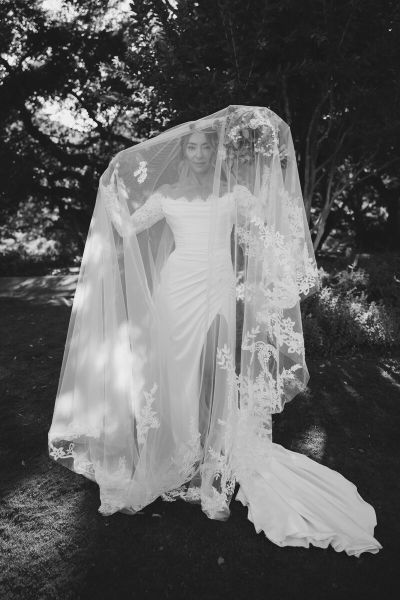 A bride on the beach with her veil