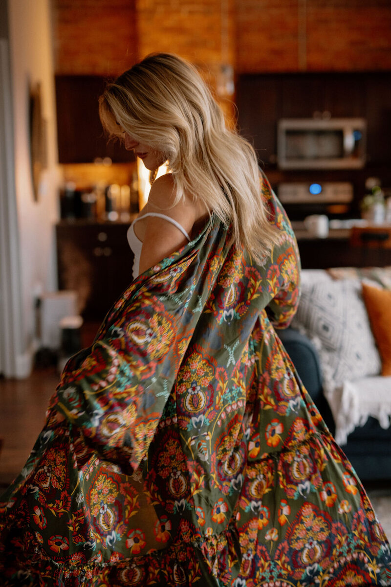 Candid portrait of a woman indoors, sitting peacefully in her home with soft natural light