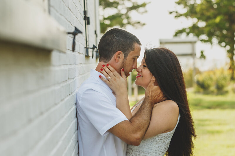 engaged couple kissing at east point light house south new jersey