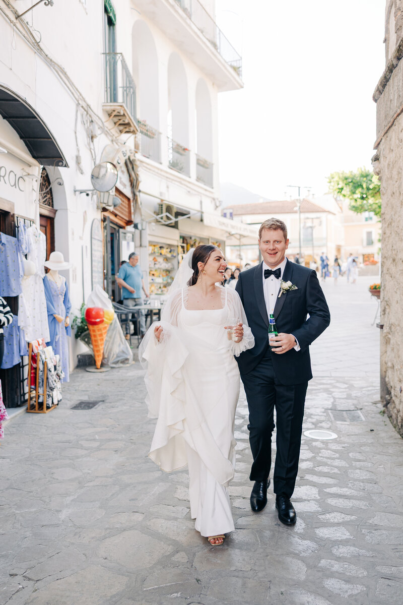 A bride and Groom walking the streets of an Italian Square