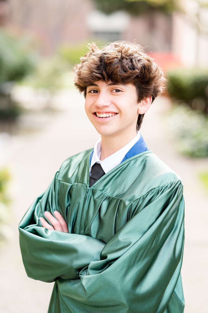 8th grade grad smiling at camera with grad gown Gia Chong Photography