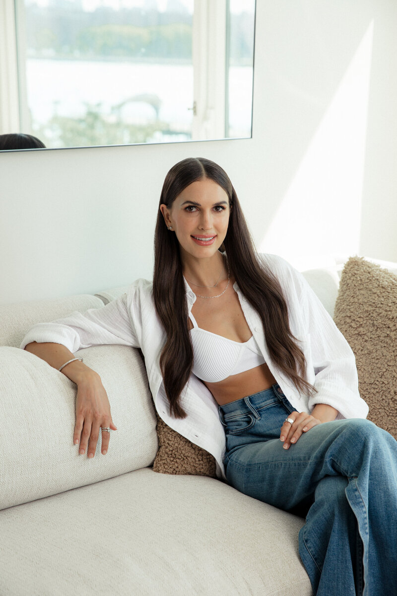 Anya Rosen, founder of Birchwell Clinic sitting on a  cream colored couch.