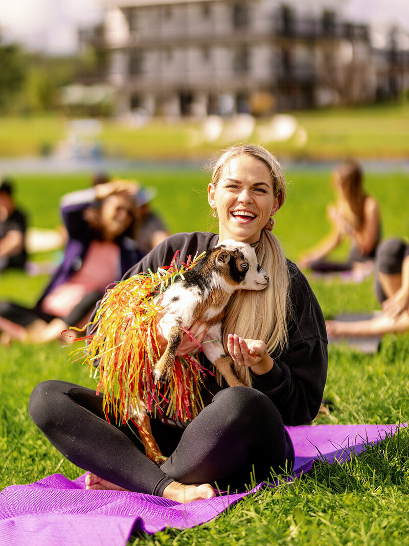 Retreat guest enjoying baby goat yoga at Gilberstville Farmhouse