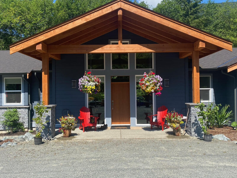 Traditional home entry design with covered entrance and custom entry door.